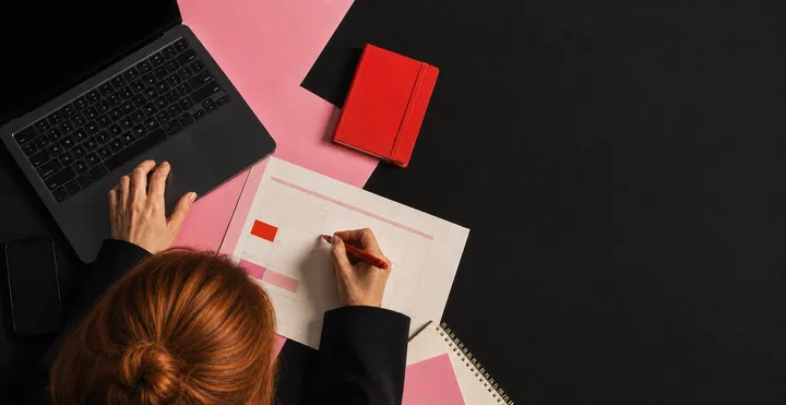 Faceless ginger-haired woman organizing a booking calendar