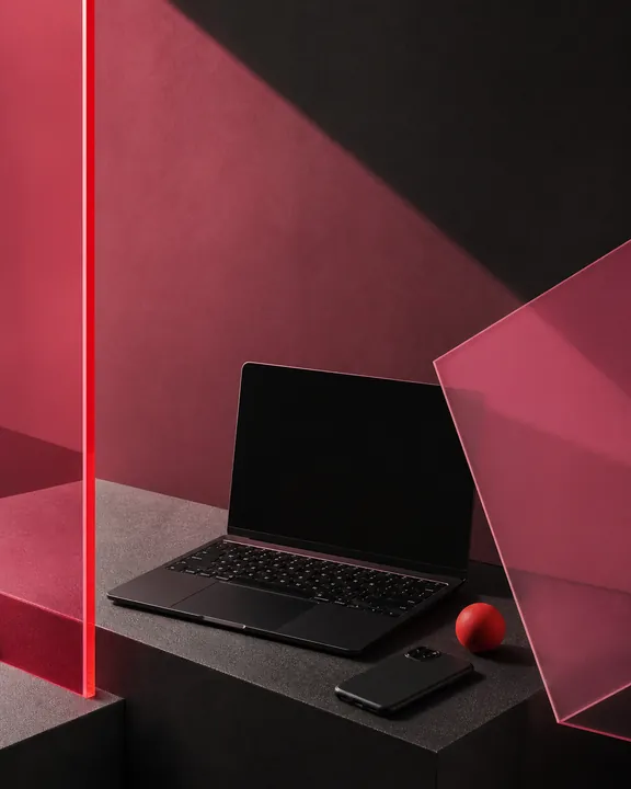 Laptop arranged among pink acrylic panels